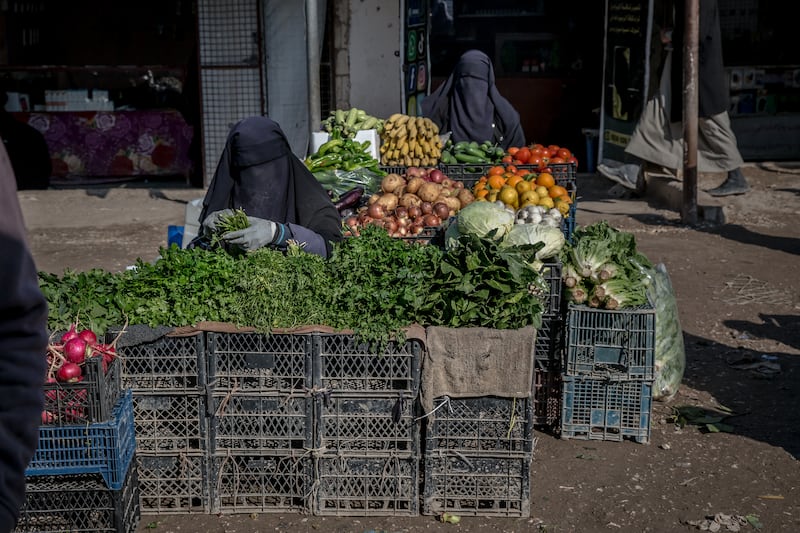 Women sell vegetables in Al Hol. Photograph: Sally Hayden