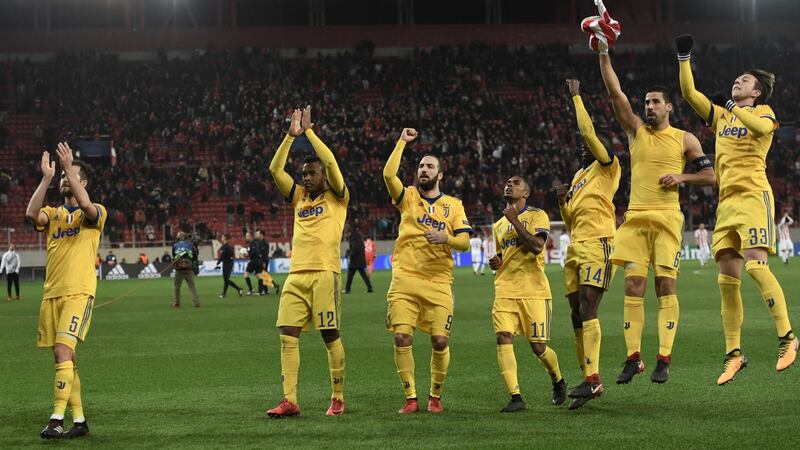 Juventus celebrate their safe passage into the last-16. Photograph: Aris Messini/AFP