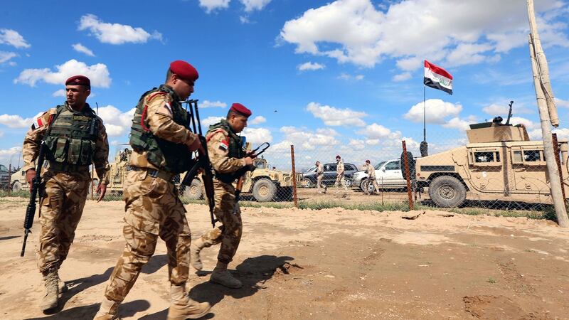 Iraqi soldiers fighting Islamic State hold a position on the front line on the outskirts of Makhmour. Photograph: Safin Hamed/AFP/Getty Images