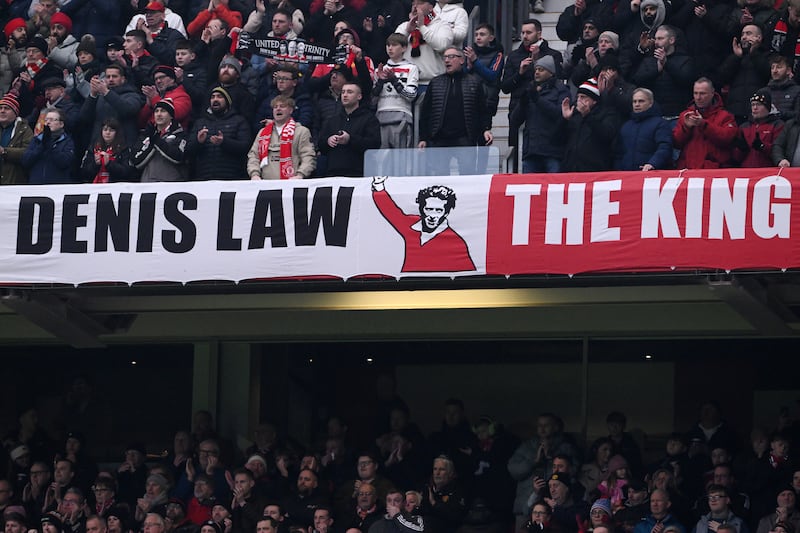 Manchester United fans displaying a banner  for Denis Law during the Premier League match against Brighton at Old Trafford on January 19th, 2025.  Photograph: Stu Forster/Getty Images