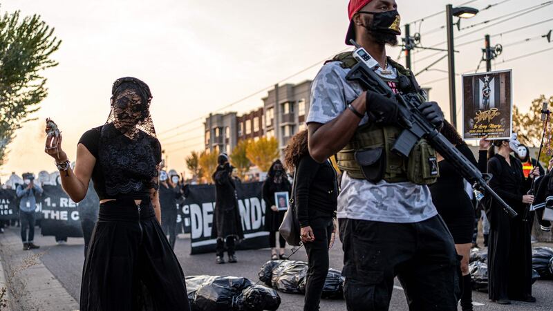 Da Mayor (aka MrNewz) (right), a member of the Minnesota Freedom Fighters (MNFF), marches with relatives of those killed by the police  after the release of Derek Chauvin on bail, in Saint Paul, Minnesota, on October 8th last. Photograph: Kerem Yucel/AFP via Getty Images