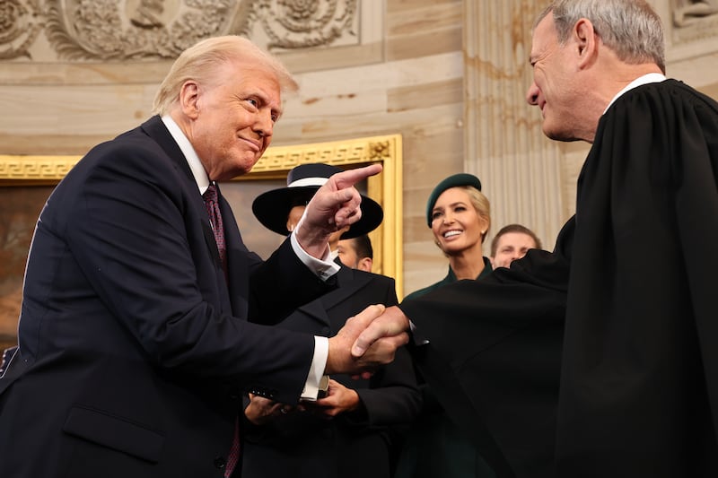 US president Donald Trump gestures to supreme court chief justice John Roberts after he was sworn in during inauguration ceremonies on Monday. Photograph: Chip Somodevilla/Getty Images