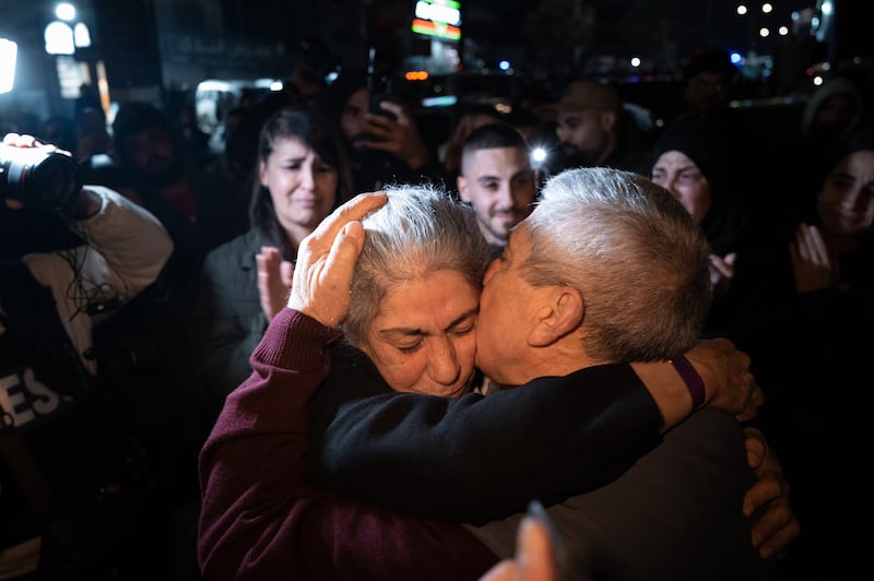 Khalida Jarrar, a leader in the Popular Front for the Liberation of Palestine, who was in the group of Palestinian prisoners released by Israel on Monday, is embraced by her husband after arriving in Ramallah. Photograph: Afif Amireh/The New York Times
                      