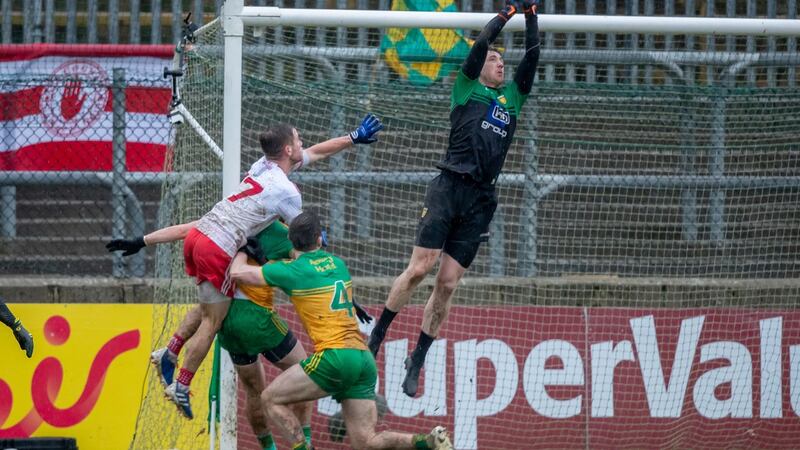 Tyrone’s Mark Bradley fails in his late challenge on Donegal goalkeeper Shaun Patton. Photo: Morgan Treacy/Inpho