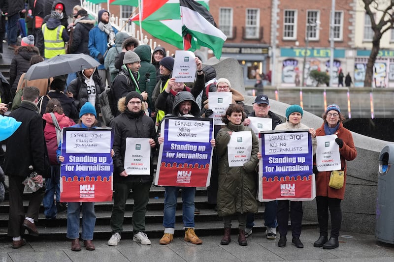 NUJ members hold a vigil on Dublin's Ha'penny Bridge in protest at the killings of journalists in Gaza by Israeli forces. Photograph: Niall Carson/PA Wire 