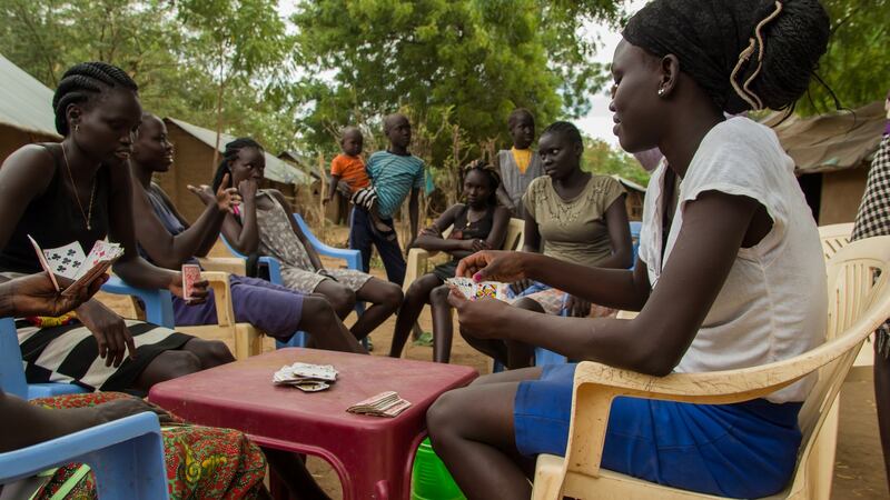 A group of young girls play cards outside their houses in Kakuma refugee camp, northern Kenya. Photograph: Ruairi Casey