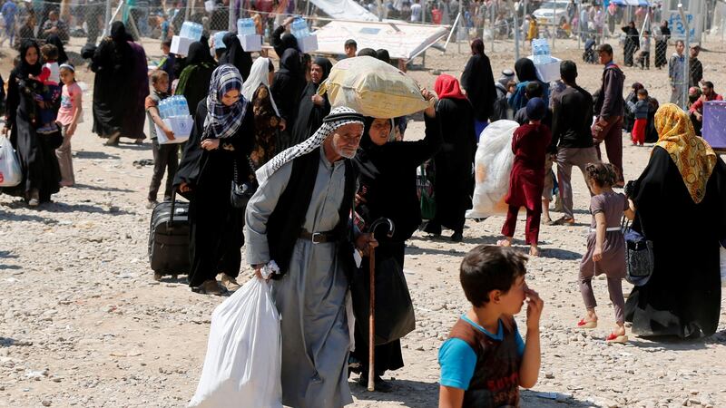 Displaced Iraqis fleeing the fighting in western Mosul on Tuesday arrive at Hammam al-Alil camp checkpoint south of the city. Photograph: Muhammad Hamed