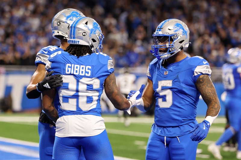 Jahmyr Gibbs of the Detroit Lions celebrates with David Montgomery and Amon-Ra St. Brown after scoring a touchdown in the second quarter of a game against the Jacksonville Jaguars. Photograph: Gregory Shamus/Getty Images