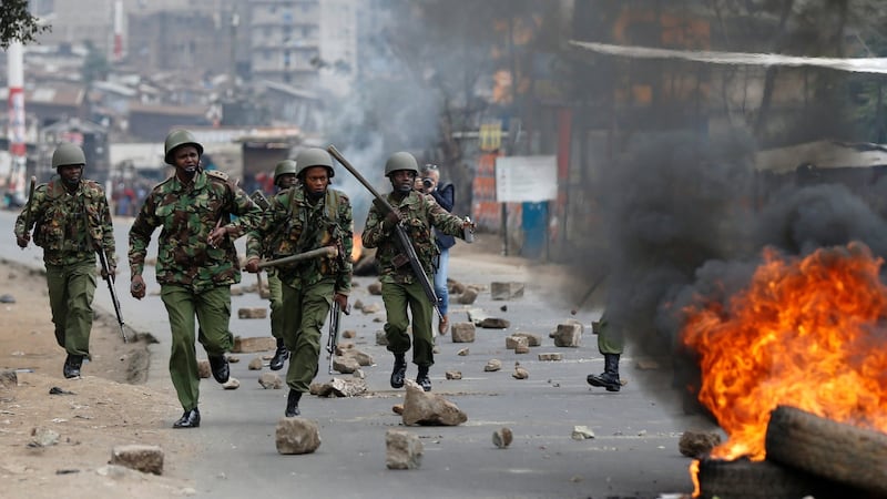 Anti-riot policemen deployed after protesters set tyres on fire in Nairobi, Kenya on Wednesday. Photograph: Thomas Mukoya/Reuters