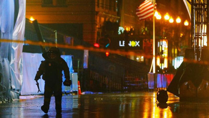 A member of the police bomb squad  walks away from a bag left on the road near the finish line of the Boston Marathon. Photograph: Brian Snyder/Reuters