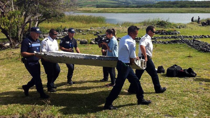 Police carry a piece of debris from an unidentified aircraft found in the coastal area of Saint-Andre de la Reunion, in the east of the French Indian Ocean island of La Reunion. Photograph: Getty