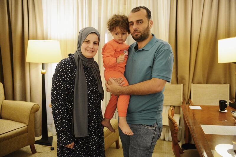 Palestinian-Irish citizen Eman Al Agha (29), her daughter Shahira (3) and husband Mohamed Laggan (36) at their hotel room in Cairo an hour after their arrival from Gaza on Thursday. Photograph: Jonathan Rashad