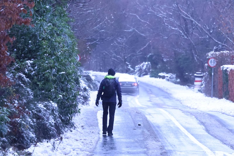 A pedestrian walks on a snow covered road in Co Wicklow on Sunday. Photograph: Stephen Collins/Collins Photos