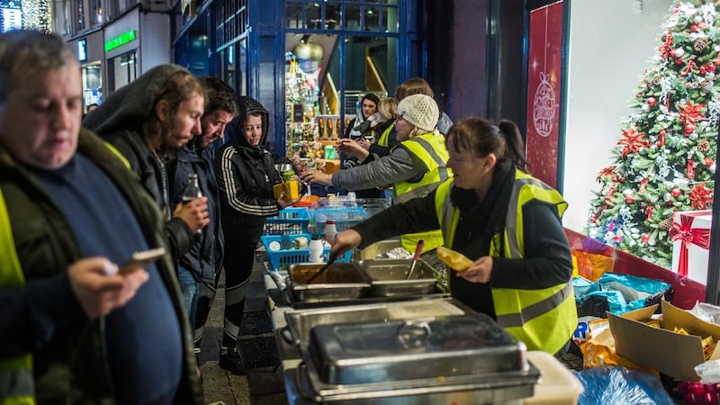 Volunteers from the Mobile Homeless Run hand  out food on Grafton Street in Dublin. Photograph: James Forde/The Irish Times