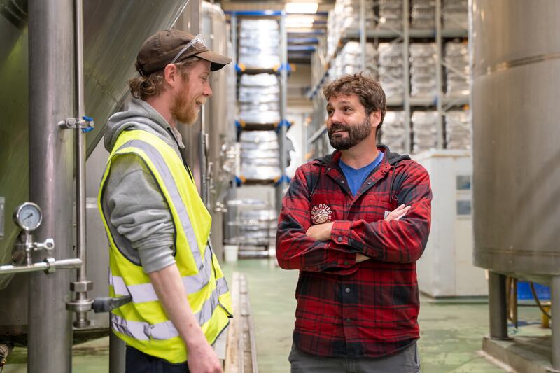 Brewer Liam Myers, and Bill, discuss the brew plans for the day ahead at Rye River Brewing Company