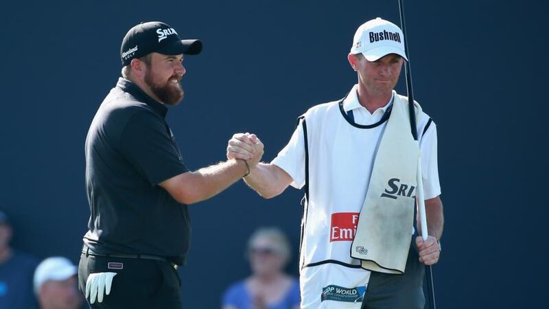 Shane Lowry of Ireland and  his caddie Dermot Byrne on the 18th green during the third round of the DP World Tour Championship at Jumeirah Golf Estates in Dubai, United Arab Emirates. Photograph:  Warren Little/Getty Images