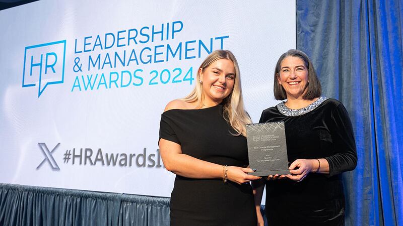 Lily Rowntree, entries lead, presents the best change management programme award to Maria Towey, Spunout 