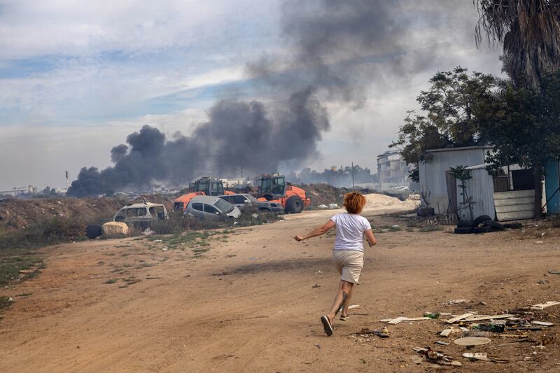 Evgenia Simanovich runs to the family home’s reinforced concrete shelter, moments after rocket sirens sounded in Ashkelon, Israel. Photograph: Tamir Kalifa/The New York Times
                      