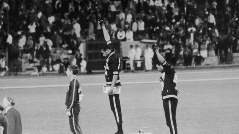 American sprinters Tommie Smith and John Carlos give the Black Power salute as they stand on the  podium at the Mexico Olympics in 1968.