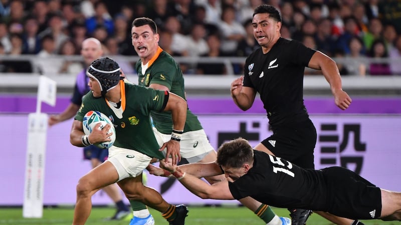 Beauden Barrett   attempts to tackle Cheslin Kolbe. Photograph: Getty Images