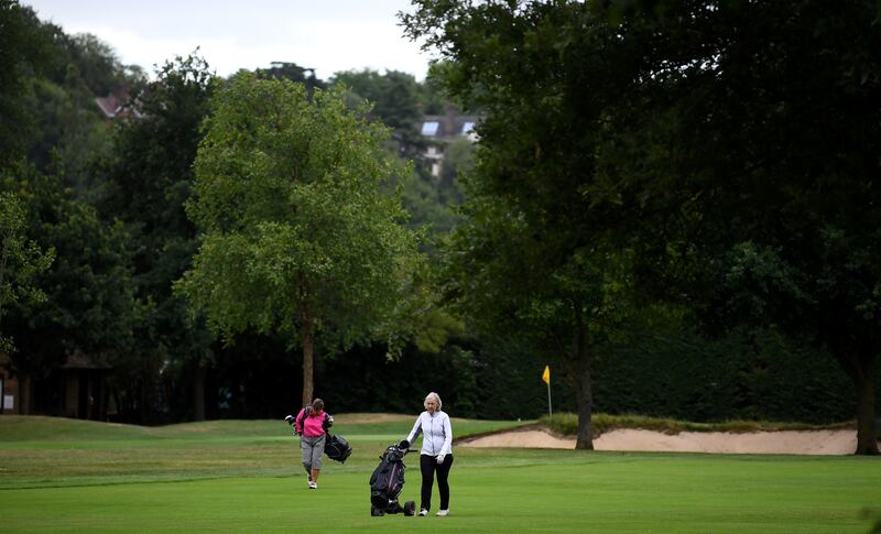 Golfers walk down the fairway at Wimbledon Golf Club in 2020, when the fairway would have been used as a carpark if the tennis tournament hand not been cancelled owing to the Covid-19 pandemic. Photograph: Alex Davidson/Getty Images