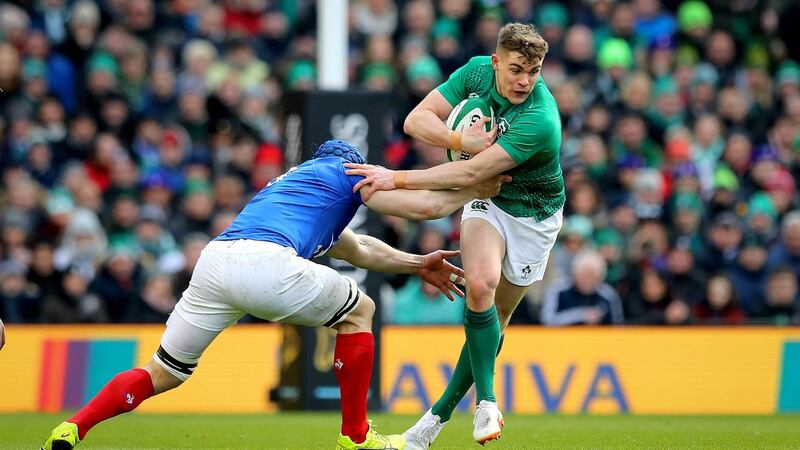 Ireland’s Garry Ringrose slips the tackle of  Wenceslas Lauret of France. Photograph: Ryan Byrne/Inpho