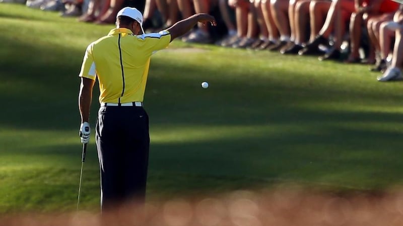 Tiger Woods of the United States drops his ball after he hit it into the water on the 15th hole during the second round of the 2013 Masters  at Augusta National. Photograph:   Mike Ehrmann/Getty Images