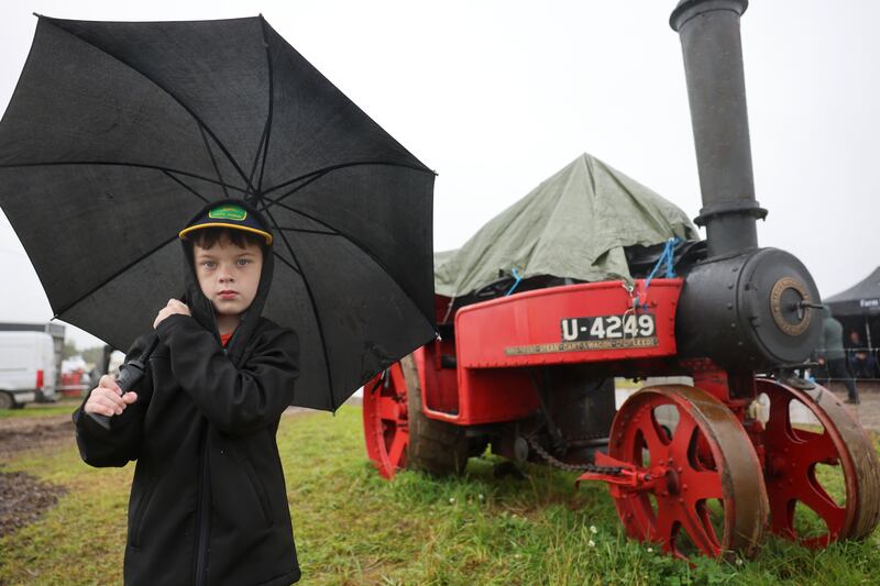 David Buttler, from Kilmacow, Co Kilkenny stands under his umbrella by a Mann Steam Wagon, owned by the Irish Steam Preservation Society, at the vintage section. Photograph: Dara Mac Dónaill/The Irish Times