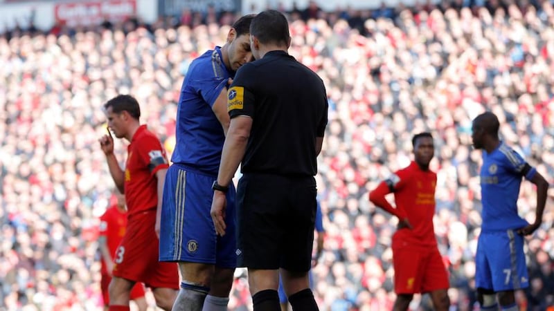 Chelsea's Branislav Ivanovic (left) shows his arm to referee Kevin Friend after an incident with Liverpool's Luis Suarez at Anfield. Photograph: Phil Noble/Reuters