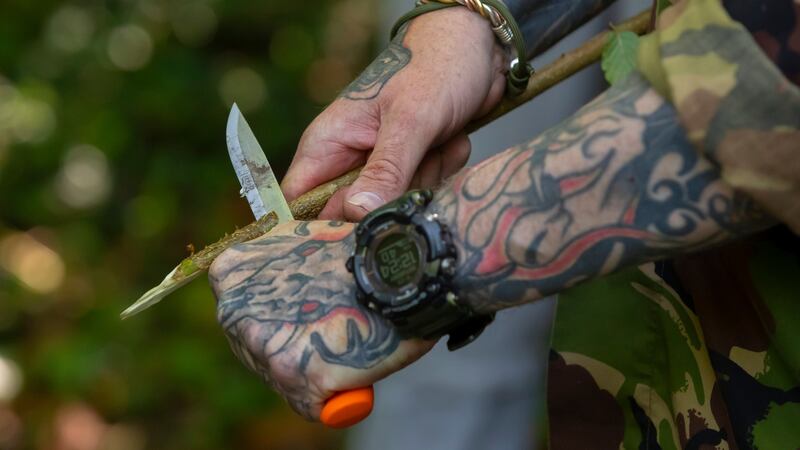 Shayne Phelan shows how to use a knife during the ‘essence of survival’ course at  the Irish National Heritage Park in Ferrycarrig, Co Wexford. Photograph: Patrick Browne