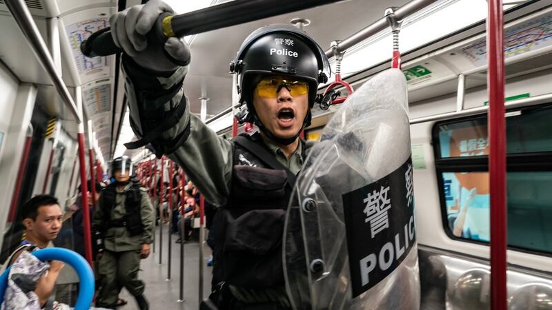 Riot police charge in a train at the Tung Chung MTR station after protesters block the transport routes to the Hong Kong International Airport on Sunday. Photograph:   Anthony Kwan/Getty Images