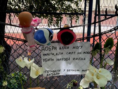 Flowers outside the school in Belgrade where a 13-year-old boy killed nine classmates and a security guard 