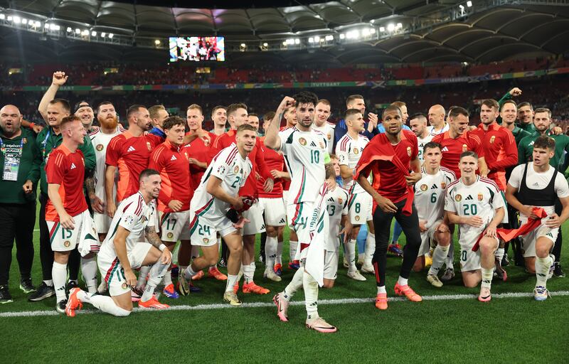 Players of Hungary pose for a photo as Dominik Szoboszlai of Hungary of Hungary holds the shirt of Barnabas Varga (not pictured), who left the field following an injury. Photograph: Carl Recine/Getty