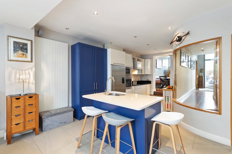 The kitchen has an unusual curved glass window