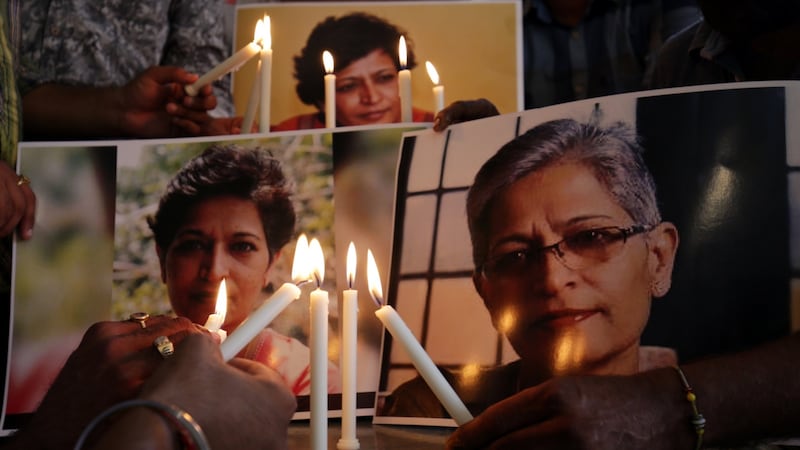 Members of the National Human Rights and Crime Control Organisation place candles near photographs of Indian journalist Gauri Lankesh during a  vigil  in Amritsar, India. Photograph: Raminder Pal Singh/EPA