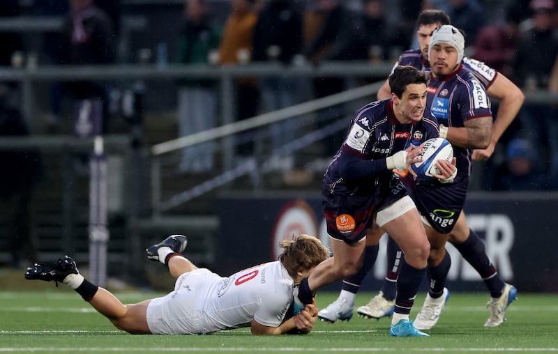 Joey Carbery of Bordeaux is tackled by Ulster’s Aidan Morgan. Photograph: Photograph: James Crombie/Inpho