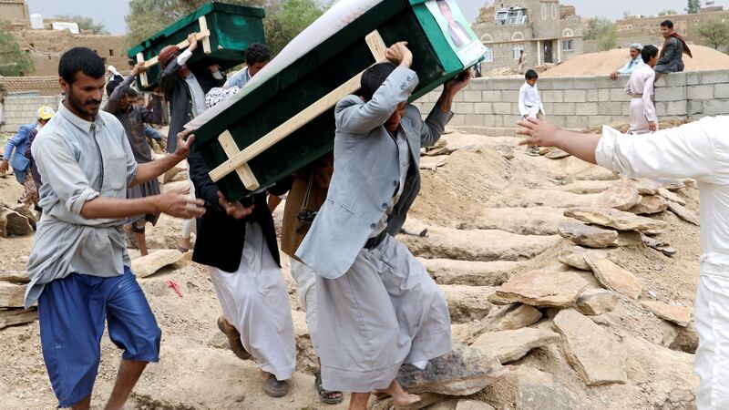 Mourners carry coffins during a funeral of people, mainly children, killed in the Saudi-led coalition air strike. Photograph:  Naif Rahma/Reuters