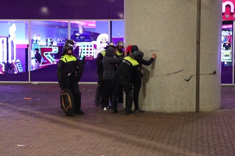 Police frisk pro-Palestinian supporters near the Ajax stadium. Photograph: InterVision/AP