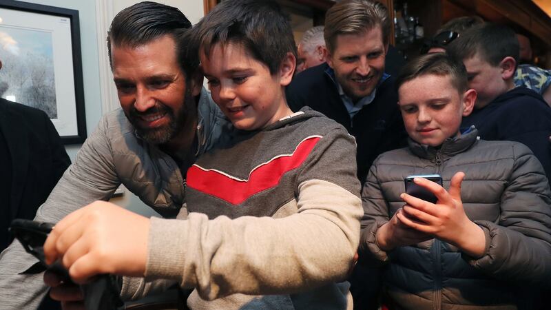 Donald Trump jnr (left) and Eric Trump, pose for selfies in Igoe’s Pub in the village of Doonbeg. Photograph: Brian Lawless/PA