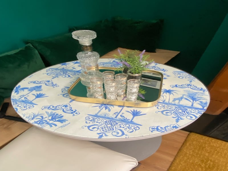 Covering a table top with old pieces of wallpaper and placing glass on top can upcycle furniture, says Natasha Rocca Devine of NRD Interiors.