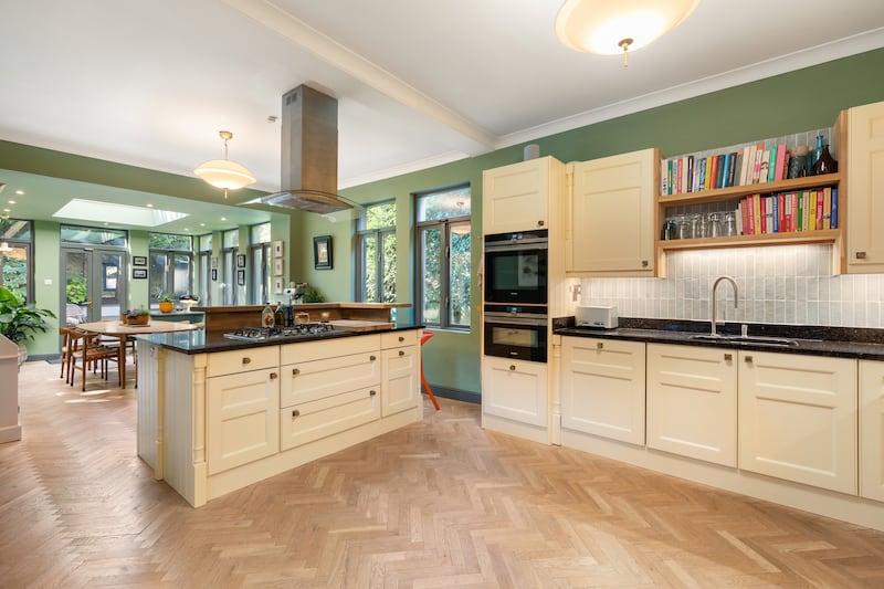 The kitchen is large and has ample storage space in the cream fitted units