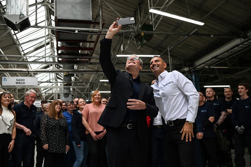 Starmer (left) takes a selfie with members of the public during a campaign trail stop at a factory in Scotland on June 21st. Photograph: Andy Buchanan/AFP via Getty