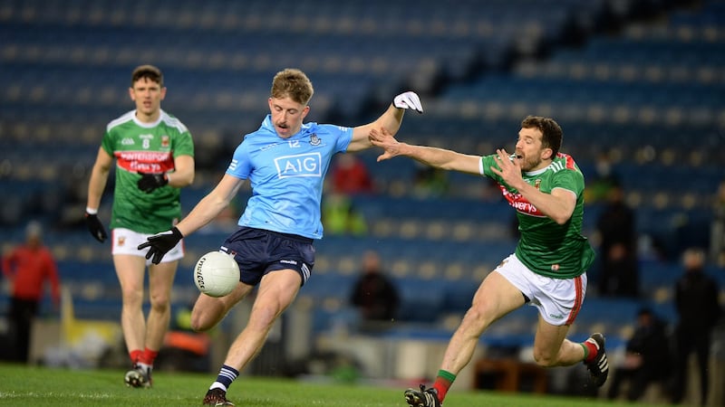 Dublin’s Seán Bugler is closely marked by  Chris Barrett of Mayo  during the All-Ireland final at Croke Park. Photograph: Dara Mac Dónaill