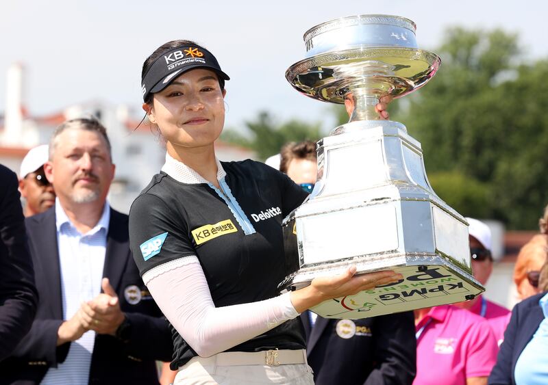 In Gee Chun of South Korea poses with the championship trophy   at Congressional Country Club 