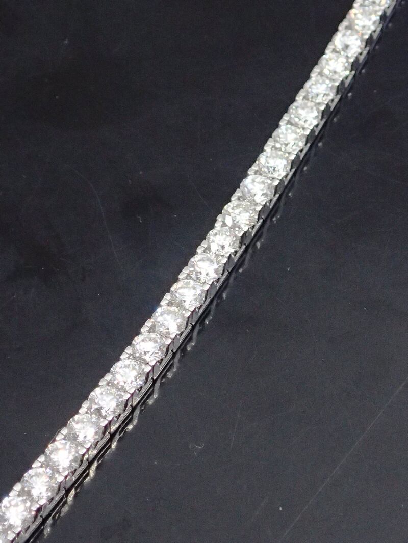 A diamond line bracelet length about7.5 inches set in 18ct gold containing 46 diamonds, total estimated weight of diamonds 9.20cts €4,000-€8.000. 