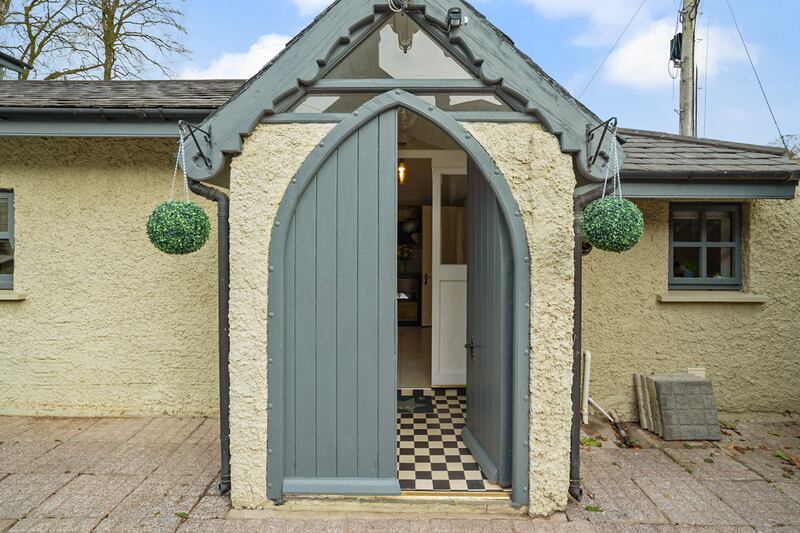 A Gothic front door marks the entrance