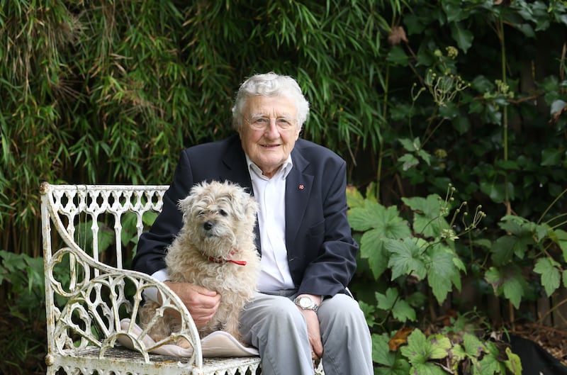 Rev Harold Good sits in the garden of his Holywood home with his Border Terrier, Judy. Photograph: Stephen Davison