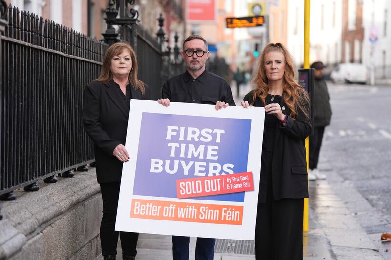 Sinn Fein representatives, Councillor Ann Graves (left) Eoin O'Broin and Councillor Janice Boylan hold up a banner on housing outside the Teachers' Club in Dublin. Niall Carson/PA Wire