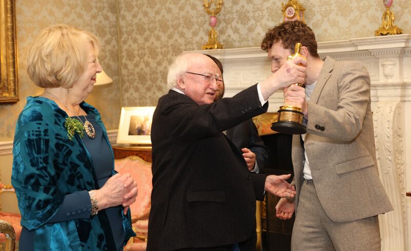 President Michael D Higgins holds the Academy Award won by director Ross White for An Irish Goodbye at Áras an Uachtaráin. Photograph: Laura Hutton