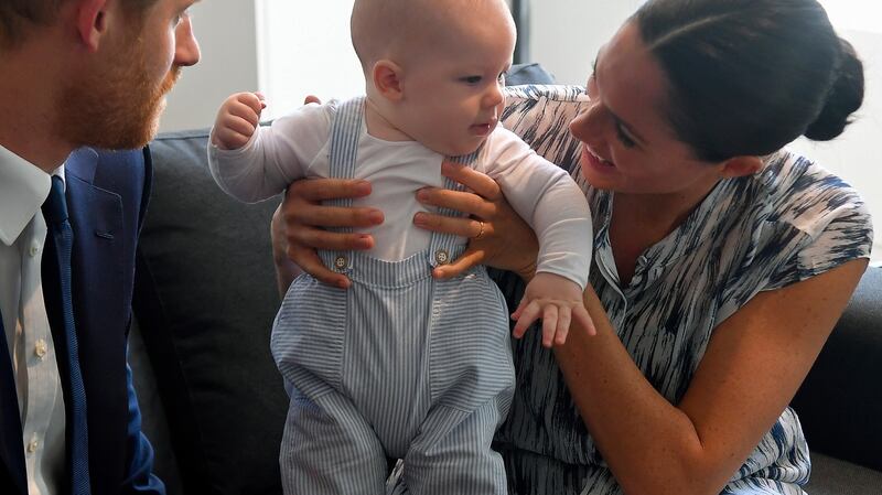 Britain’s Prince Harry (L), and hisMeghan, Duchess of Sussex, holding their son Archie during a visit to the Desmond and  Leah Tutu Legacy Foundation. Photgraph: Toby Melville/EPA/pool